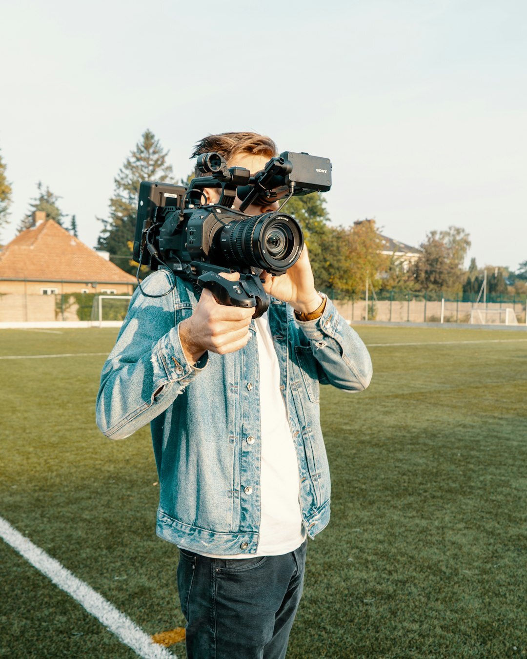 Camera operator filming a live news report outdoors